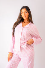 Load image into Gallery viewer, Ladies jersey stripe pyjamas in Light Pink and White with a button up shirt, satin contrast piping in White and a pocket on the right of the chest with personalisation above the pocket. Matching trousers with pockets on either side and an adjustable tie around the waist. The perfect gift for her.