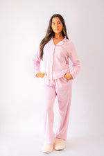 Load image into Gallery viewer, Ladies jersey stripe pyjamas in Light Pink and White with a button up shirt, satin contrast piping in White and a pocket on the right of the chest with personalisation above the pocket. Matching trousers with pockets on either side and an adjustable tie around the waist. The perfect gift for her.