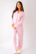 Load image into Gallery viewer, Ladies jersey stripe pyjamas in Light Pink and White with a button up shirt, satin contrast piping in White and a pocket on the right of the chest with personalisation above the pocket. Matching trousers with pockets on either side and an adjustable tie around the waist. The perfect gift for her.