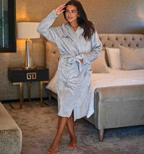 This ladies personalised dressing gown in Light Grey is made out of a super soft fleece fabric, perfect for keeping you warm on a cold day. This dressing gown has a hood to the back, pockets on either side and a tie around the waist. This dressing gown can be personalised with any name you wish, for special requests please leave this in the notes section of your order. This will be embroidered. You can select the colour of the thread this will be personalised in.