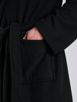 Load image into Gallery viewer, Here we have from the mens collection a personalised waffle material with Borg lining black dressing gown. You could have this embroidered with a name of your choice - embroidered in a white cotton. It has a Borg lined hood, two front pockets and a wrap around tie at the waist. What a great personalised gift such a great way to keep warm on the colder evenings.