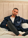 Our mens plush hooded dressing gown in Navy is made from a super soft fabric, then length is just to the knee, with a hood to the back, pockets on either side and a tie around the waist for adjusting. Completed with your personalised name embroidered to the chest. 