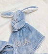 our Babies personalised bunny comforter in Dusky Blue is crafted from super soft plush material, this comforter will keep your baby snug and content. Complete with your babies name personalised/embroidered to the front.