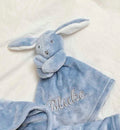 our Babies personalised bunny comforter in Dusky Blue is crafted from super soft plush material, this comforter will keep your baby snug and content. Complete with your babies name personalised/embroidered to the front.