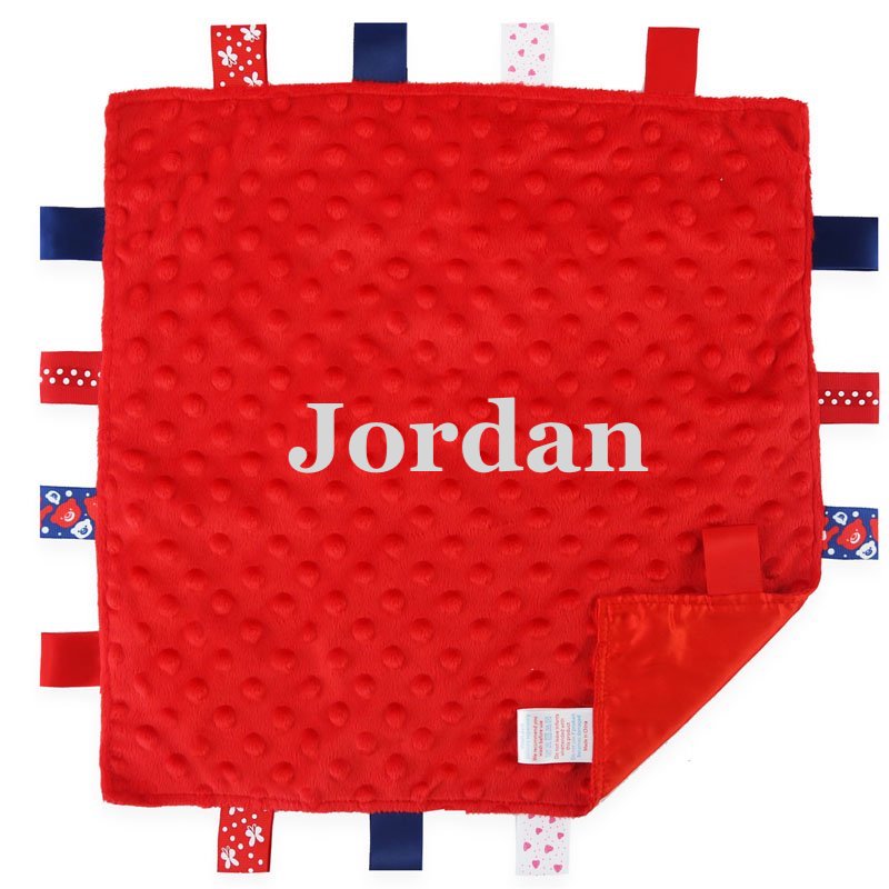 Babies unisex red personalised soft plush comforter. Personalisation embroidered in the middle in a white cotton which complements the accent tags around the edges. A nice square soft comforter to help keep the little one content.