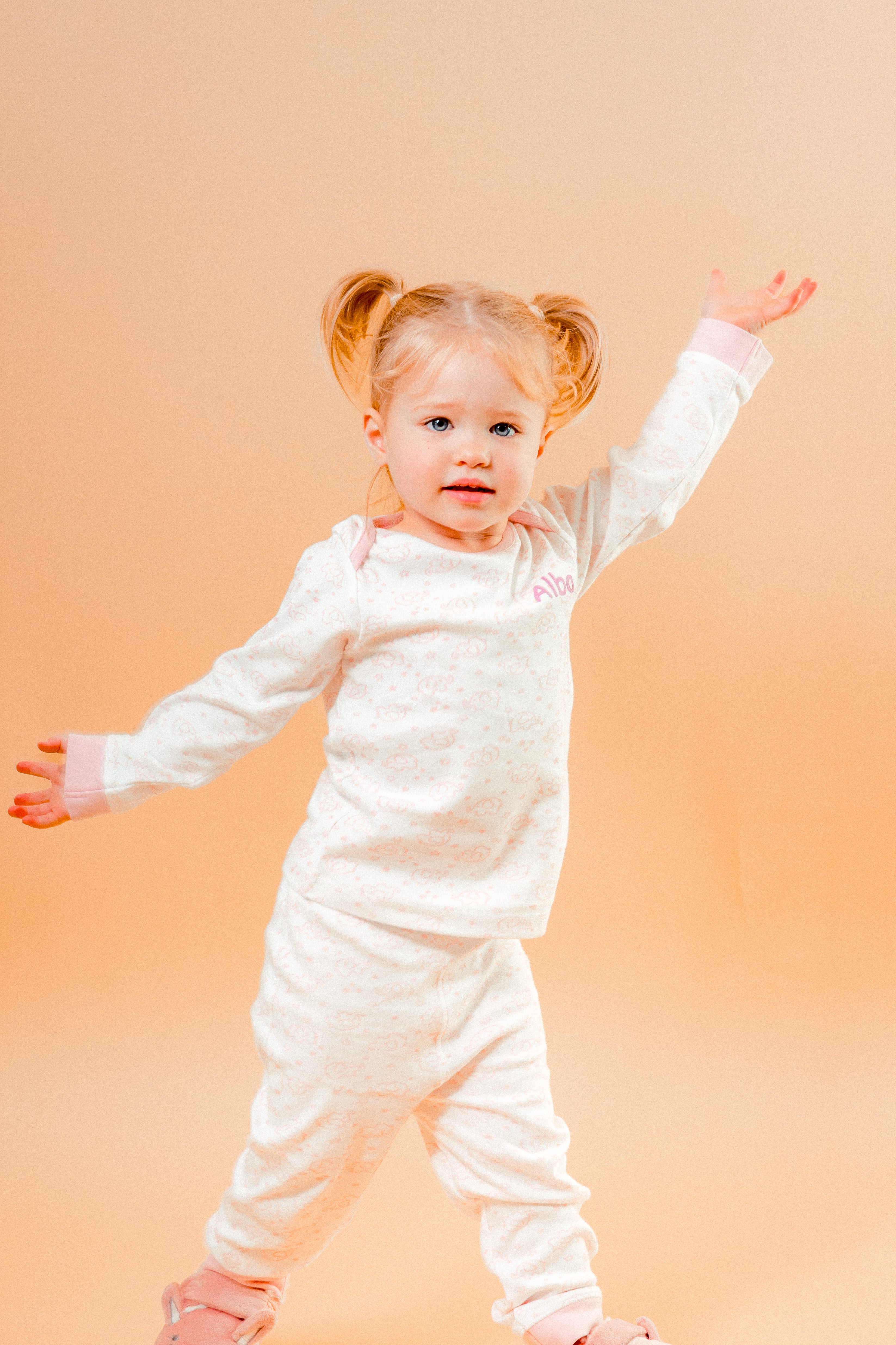 A sweet little set of bay/toddler girls personalised pyjama set white with light pink elephant print design  with matching light pink cuffs. Personalised on the left chest with the name in pink. A lovely soft pyjama set which would be a great addition to any littles ones bed time wardrobe. 