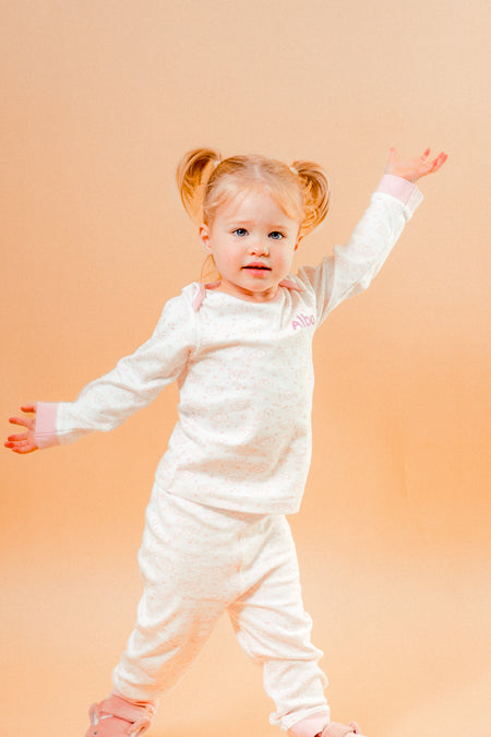 A sweet little set of bay/toddler girls personalised pyjama set white with light pink elephant print design  with matching light pink cuffs. Personalised on the left chest with the name in pink. A lovely soft pyjama set which would be a great addition to any littles ones bed time wardrobe. 