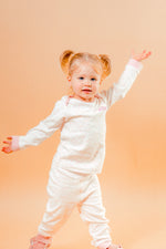 Load image into Gallery viewer, A sweet little set of bay/toddler girls personalised pyjama set white with light pink elephant print design  with matching light pink cuffs. Personalised on the left chest with the name in pink. A lovely soft pyjama set which would be a great addition to any littles ones bed time wardrobe. 
