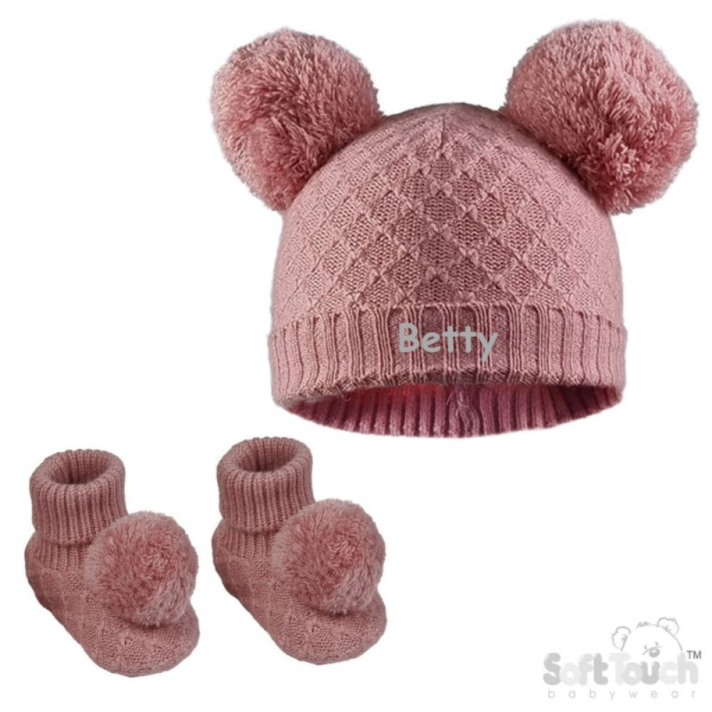 Baby girl cable knitted hat and bootees personalised along the front of the hat. Soft cotton in a lovely rose pink colour, both the hat and bootees complete with cute pom pom's. A perfect gift to keep those little ones warm through those colder months.
