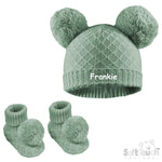Load image into Gallery viewer, Baby unisex cable knitted hat and bootees personalised along the front of the hat. Soft cotton in a lovely sage green colour, both the hat and bootees complete with cute pom pom's. A perfect gift to keep those little ones warm through those colder months.
