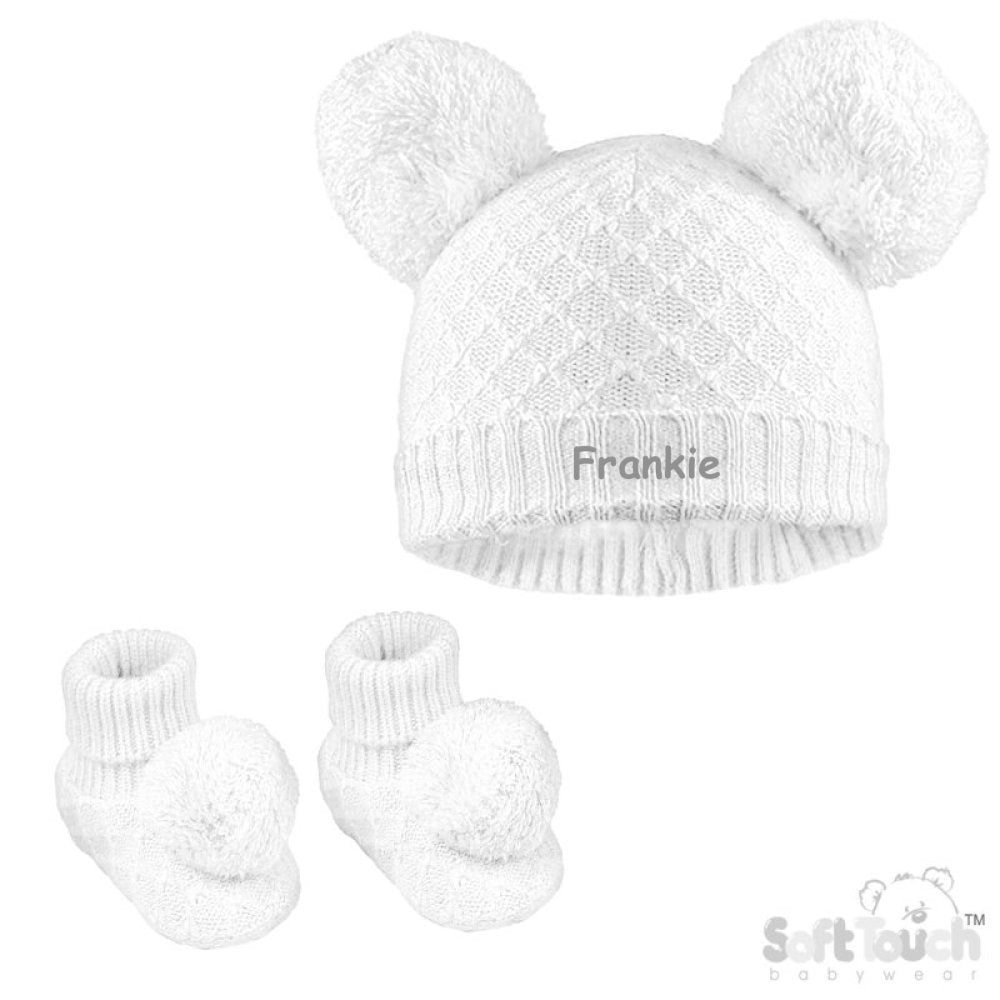 Baby unisex cable knitted hat and bootees personalised on the front of the hat. Soft cotton in a lovely white colour. The hat and bootees both complete with cute pom pom's. A perfect gift to keep those little ones warm through those colder months.