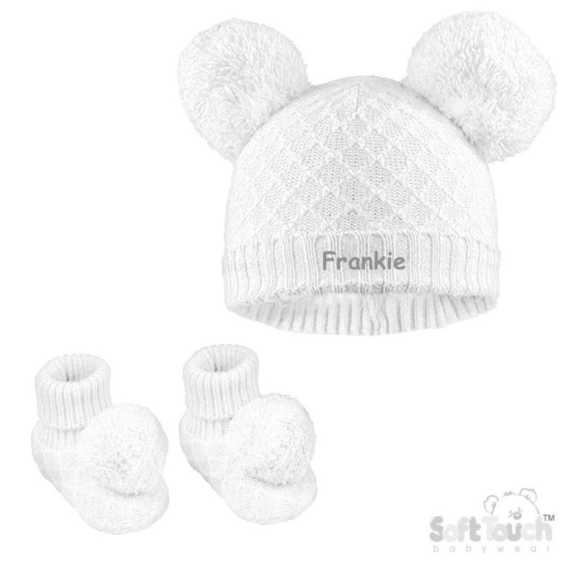 Baby unisex cable knitted hat and bootees personalised on the front of the hat. Soft cotton in a lovely white colour. The hat and bootees both complete with cute pom pom's. A perfect gift to keep those little ones warm through those colder months.