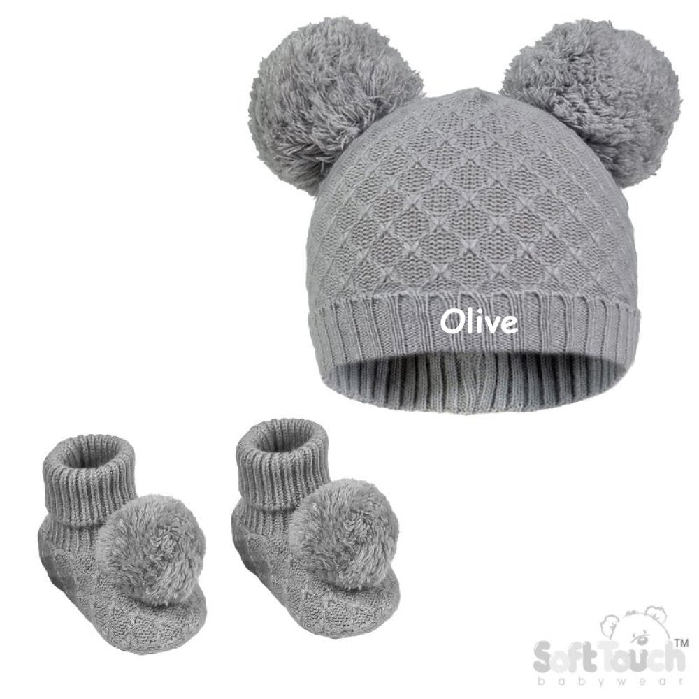 Baby unisex cable knitted hat and bootees personalised soft cotton in a lovely grey colour. The hat and bootees both complete with cute pom pom's. A perfect gift to keep those little ones warm through those colder months.