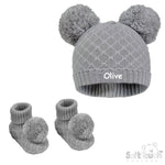 Load image into Gallery viewer, Baby unisex cable knitted hat and bootees personalised soft cotton in a lovely grey colour. The hat and bootees both complete with cute pom pom's. A perfect gift to keep those little ones warm through those colder months.

