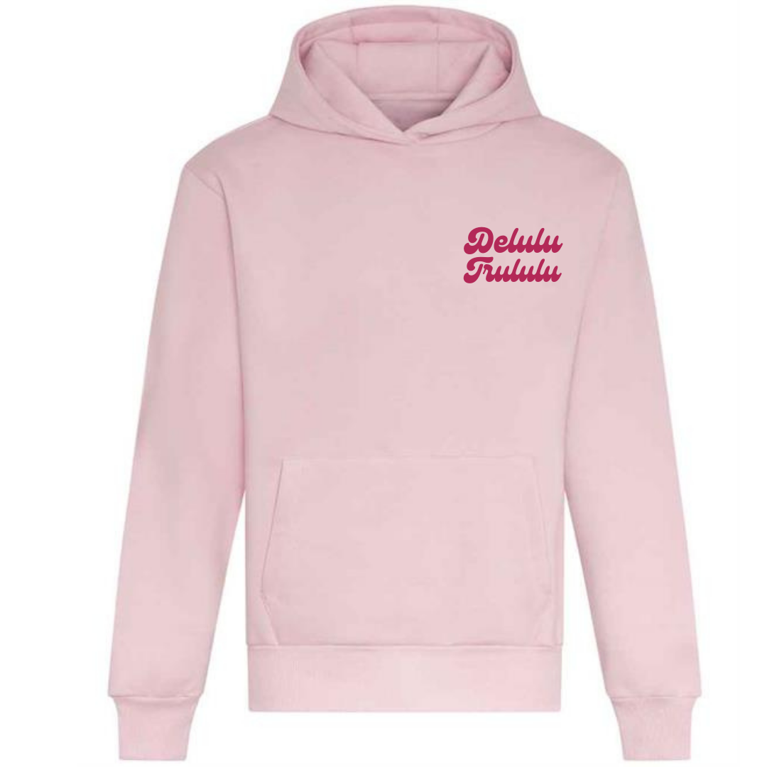 A comfortable ladies oversized light pink cotton hoodie with a printed design in a curvy font hot pink  writing to the left chest on the front  ... Watch Delulu become Trululu... A catchy design sure to catch peoples eye ! 
