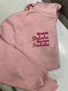 A comfortable ladies oversized light pink cotton hoodie with a printed design in a curvy hot pink printing to the left chest on the front  ... Watch Delulu become Trululu... A catchy design sure to catch peoples eye ! 
