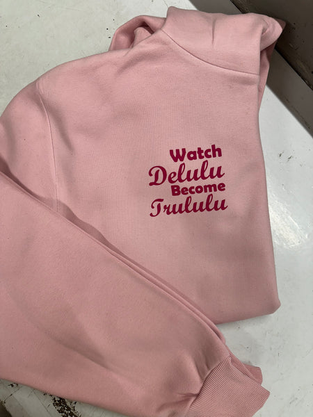A comfortable ladies oversized light pink cotton hoodie with a printed design in a curvy hot pink printing to the left chest on the front  ... Watch Delulu become Trululu... A catchy design sure to catch peoples eye ! 