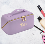 Load image into Gallery viewer, Ladies personalised make up bag PU material with an open flat design and a name of your choice personalised on the front with embroidery. Lilac colour with gold zips and gold embroidery for the personalised name. 
