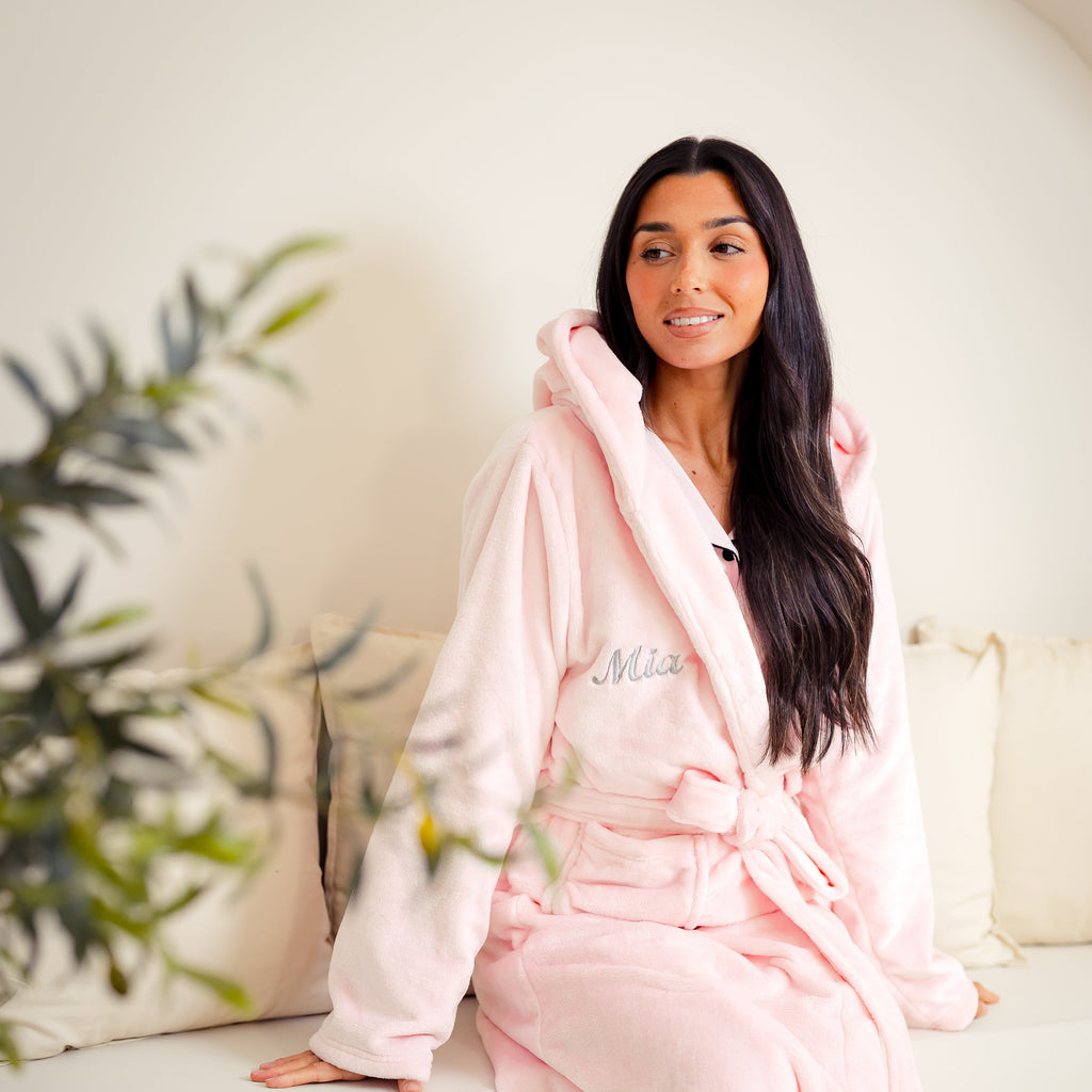 Ladies plush maxi personalised dressing gown in a luxurious Light Pink colour. Made from super soft thick fabric, maxi length, large hood to the back and adjustable tie around the waist. Complete with a special touch of personalisation to the chest - this is embroidered especially for you. Making the perfect personalised gift for her. 