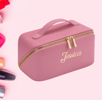 Load image into Gallery viewer, Ladies personalised make up bag PU material with an open flat design and a name of your choice personalised on the front with embroidery. Dusky colour with gold zips and gold embroidery for the personalised name. 
