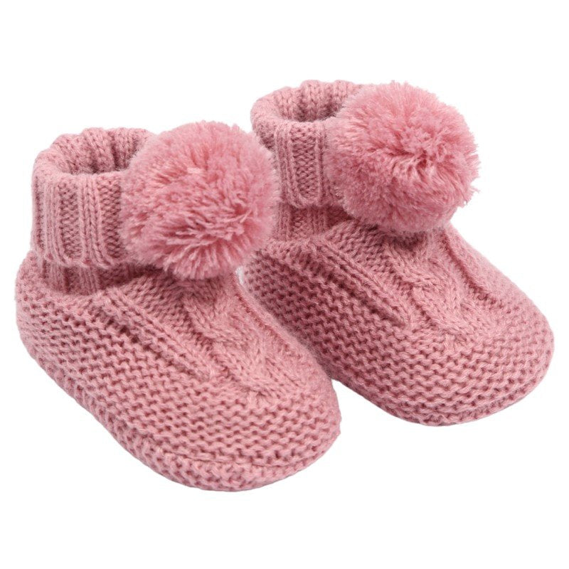 baby cable knit pom pom bootees | unisex knitted baby bootees | cable knit baby booties with pom poms | cosy newborn knitted bootees