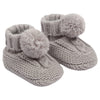 baby cable knit pom pom bootees | unisex knitted baby bootees | cable knit baby booties with pom poms | cosy newborn knitted bootees