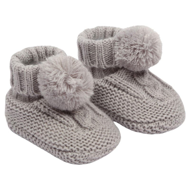 baby cable knit pom pom bootees | unisex knitted baby bootees | cable knit baby booties with pom poms | cosy newborn knitted bootees