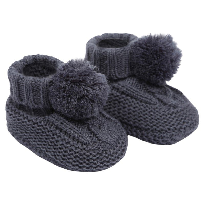 baby cable knit pom pom bootees | unisex knitted baby bootees | cable knit baby booties with pom poms | cosy newborn knitted bootees