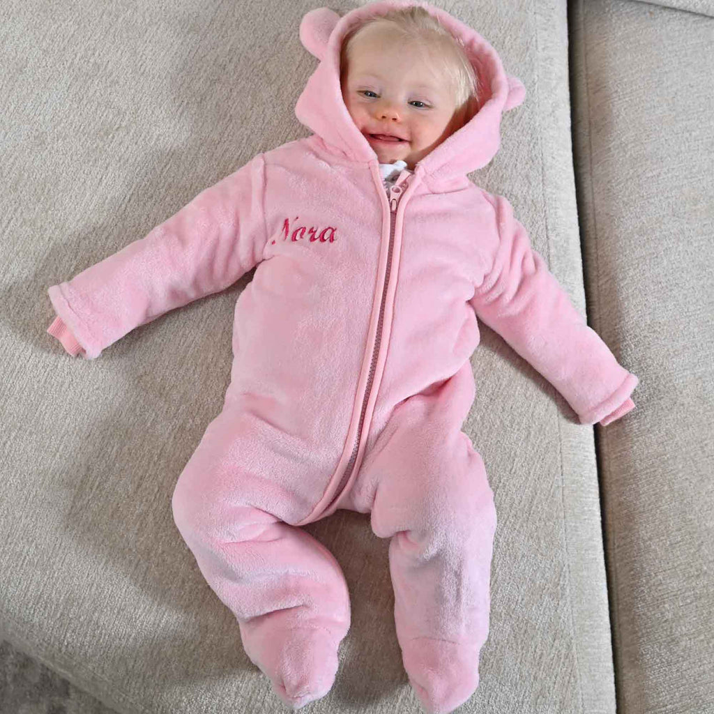 image of baby wearing pink personalised pram suit from Lulabay