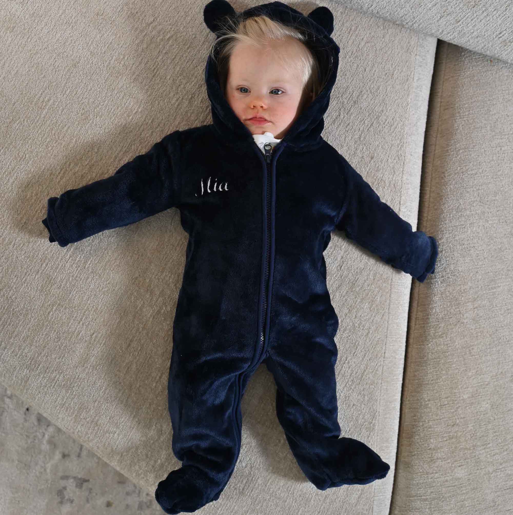 image of baby wearing navy blue personalised pram suit from Lulabay